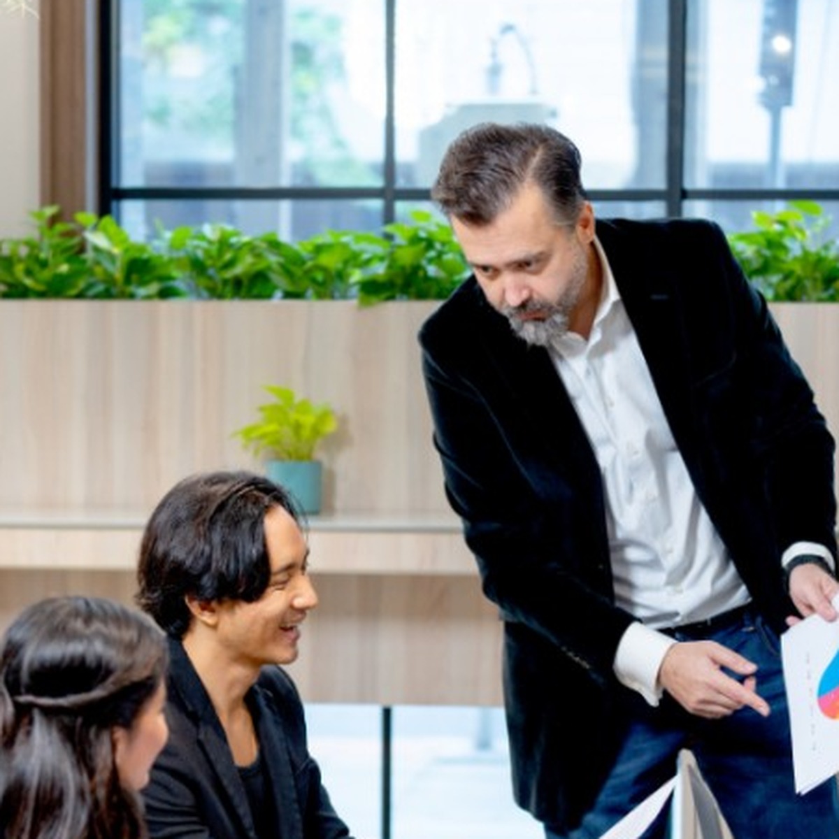 Team reviewing hiring data and charts in a modern office